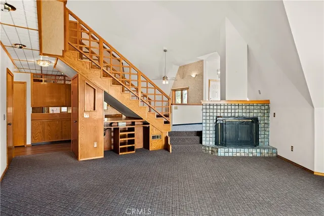a view of a livingroom with furniture and staircase