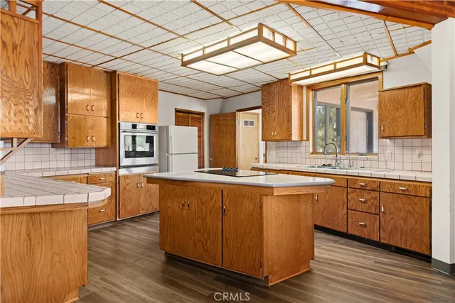 a kitchen with a refrigerator and cabinets