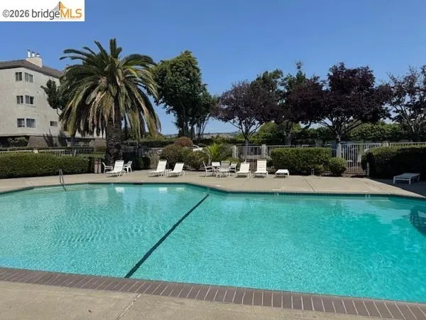 a view of a swimming pool with outdoor space and seating area