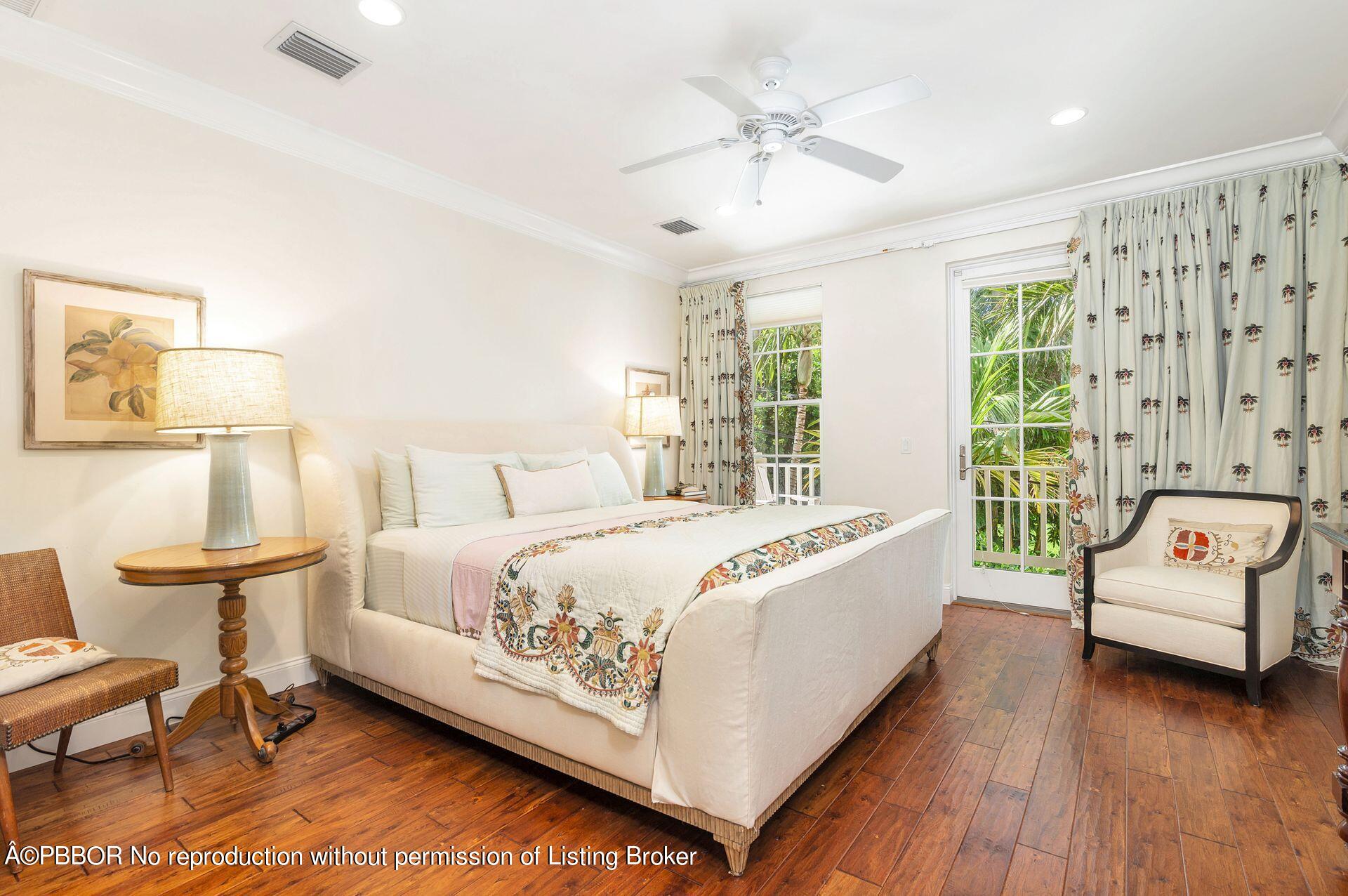 135 Root Trail, Unit A Palm Beach, FL 33480 - Photo 13 of 25 a spacious bedroom with a bed and a chair