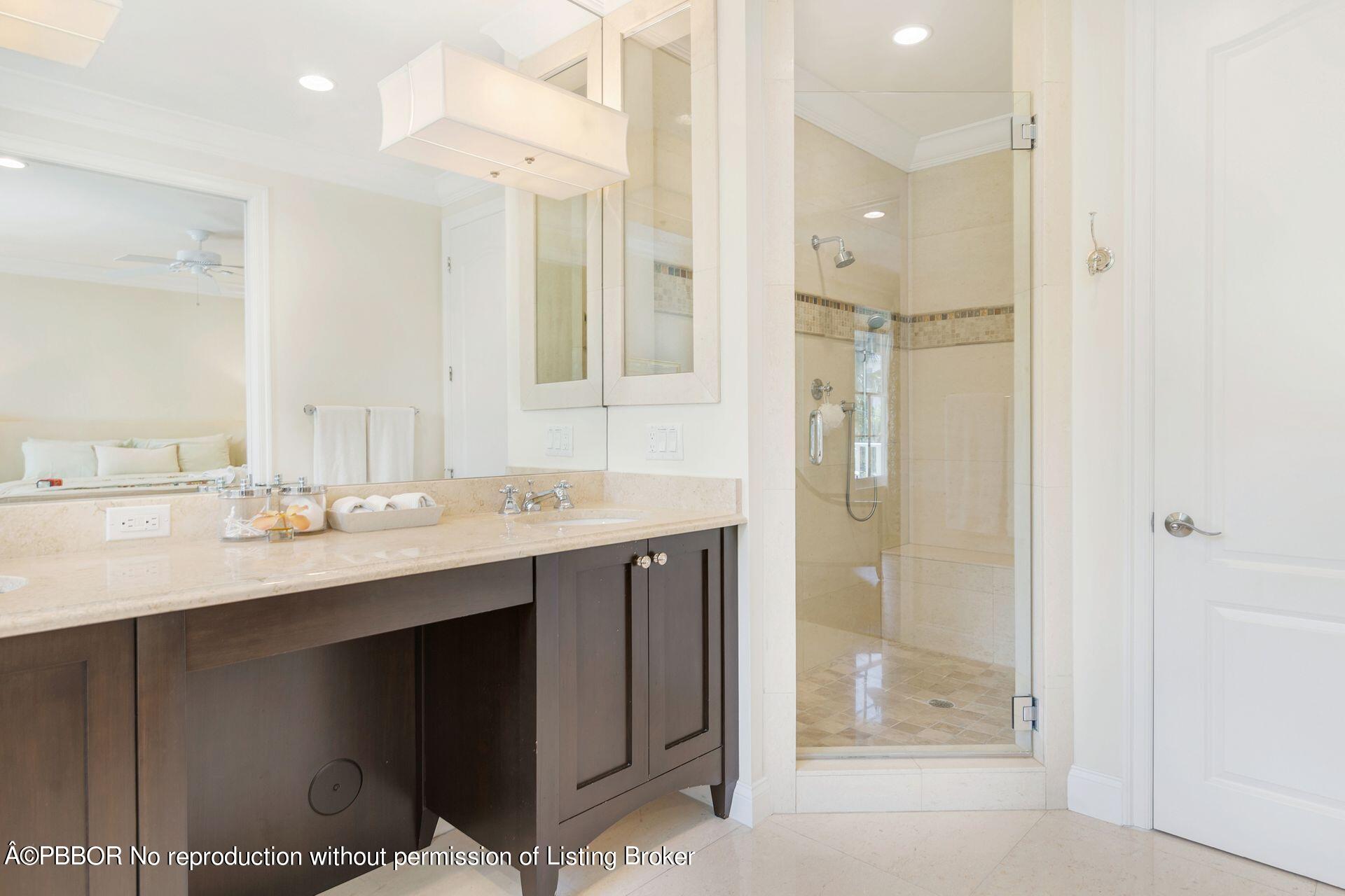 135 Root Trail, Unit A Palm Beach, FL 33480 - Photo 15 of 25 a bathroom with a sink shower and a mirror