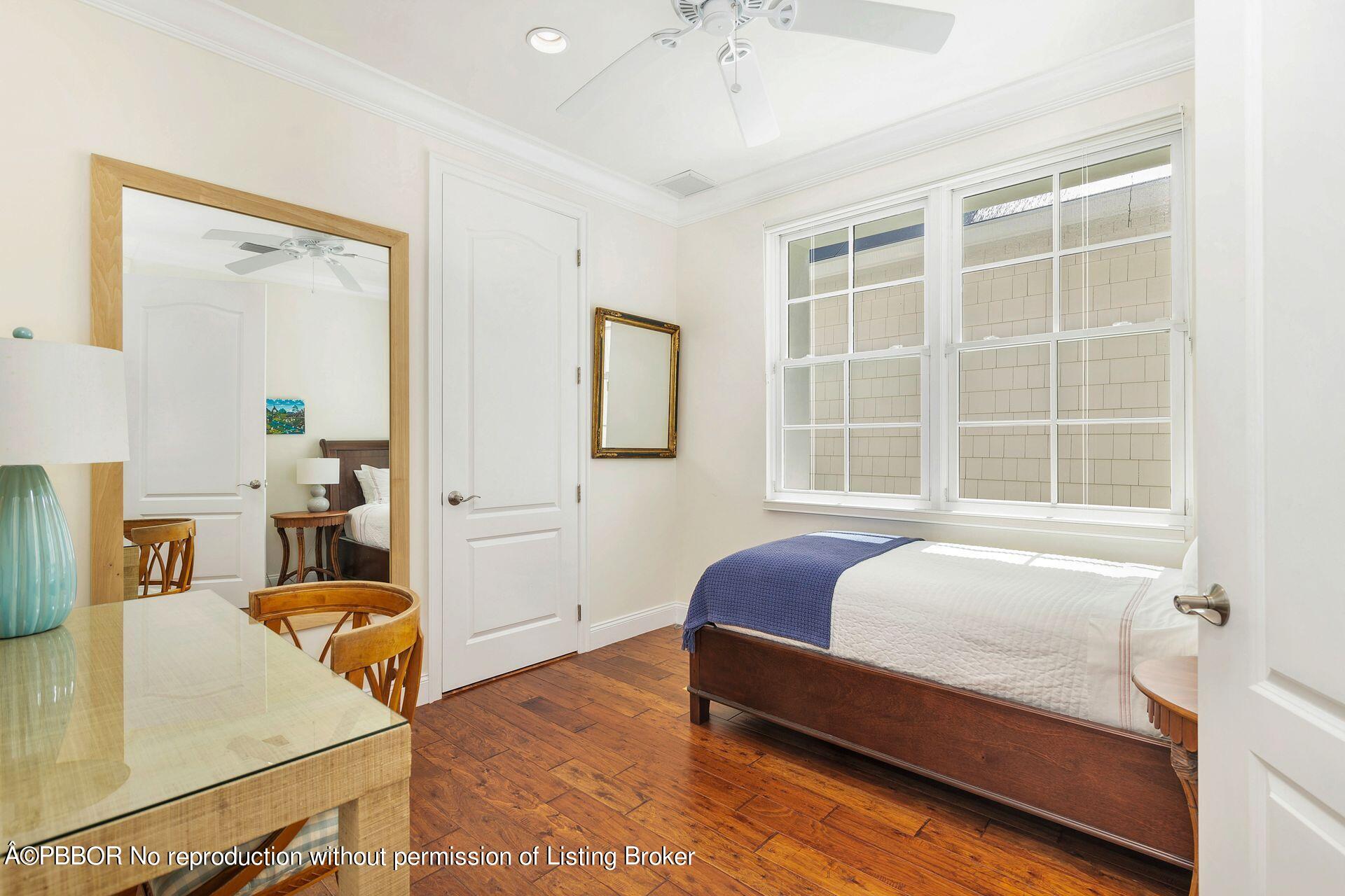 135 Root Trail, Unit A Palm Beach, FL 33480 - Photo 17 of 25 a bedroom with a bed and wooden floor