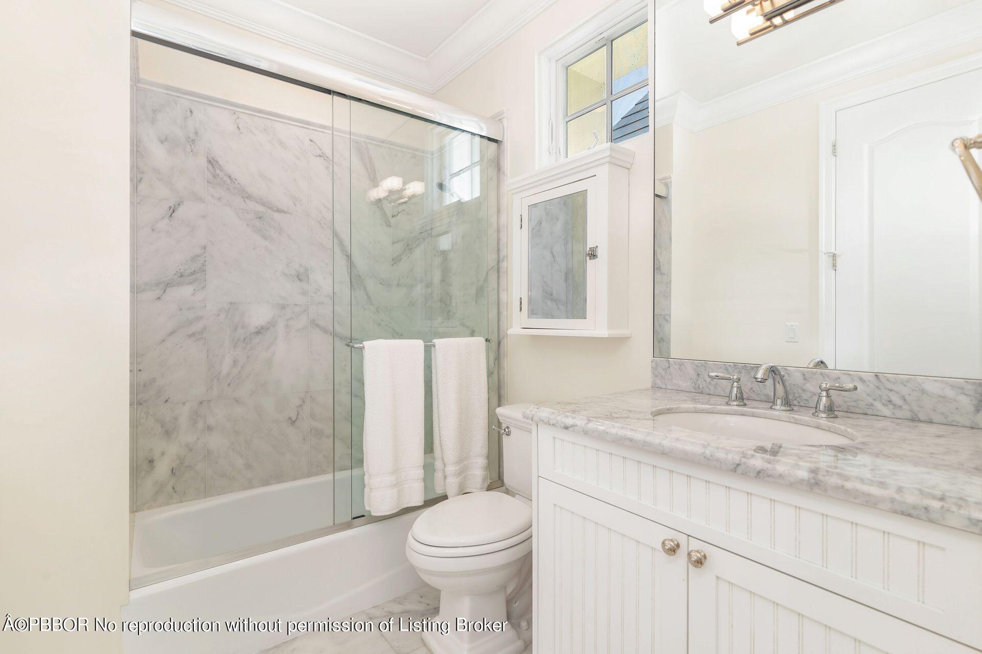 135 Root Trail, Unit A Palm Beach, FL 33480 - Photo 18 of 25 a bathroom with a granite countertop sink toilet and shower