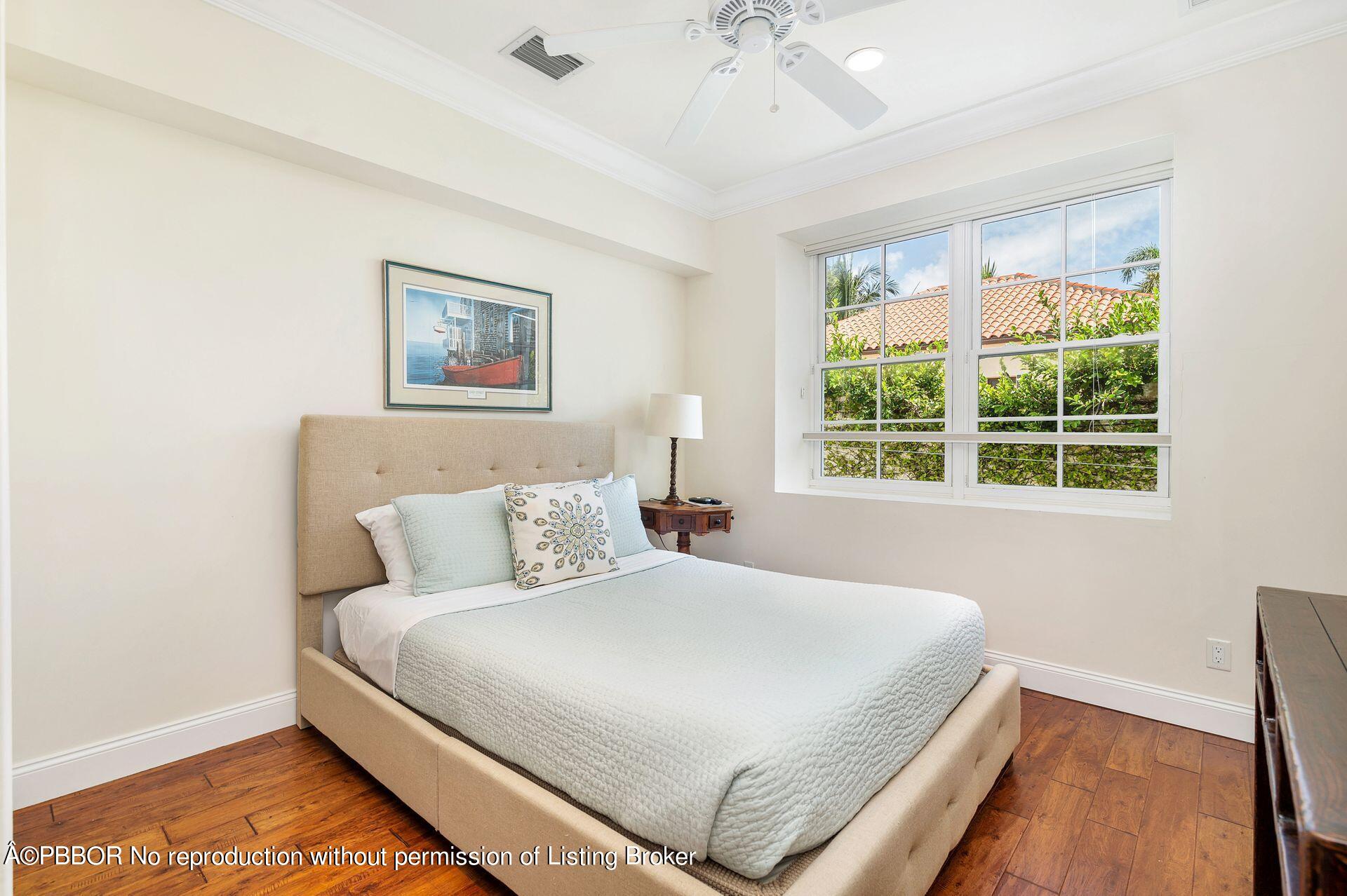 135 Root Trail, Unit A Palm Beach, FL 33480 - Photo 19 of 25 a bedroom with a bed and a window