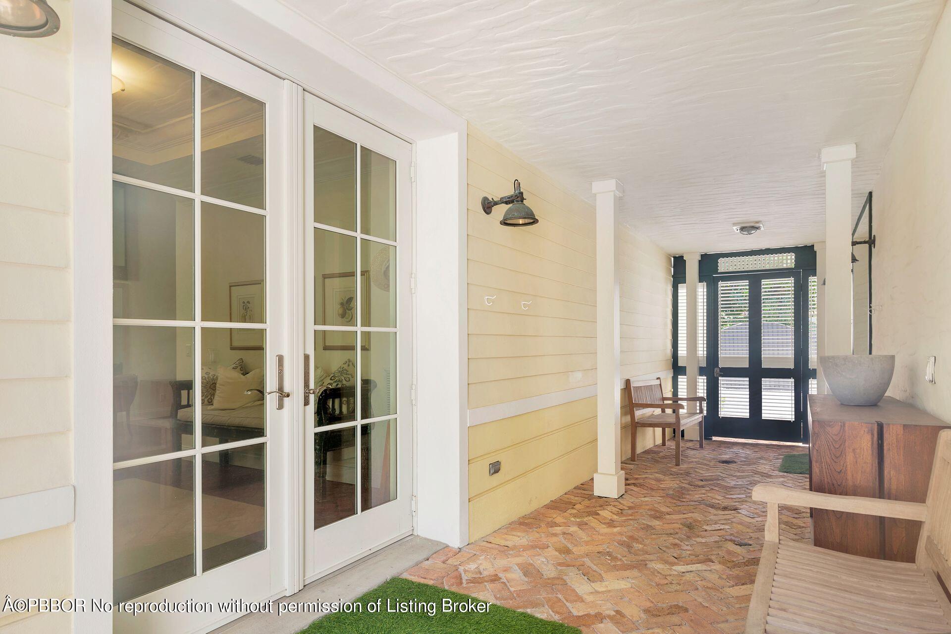 135 Root Trail, Unit A Palm Beach, FL 33480 - Photo 4 of 25 a view of front door with wooden floor and furniture