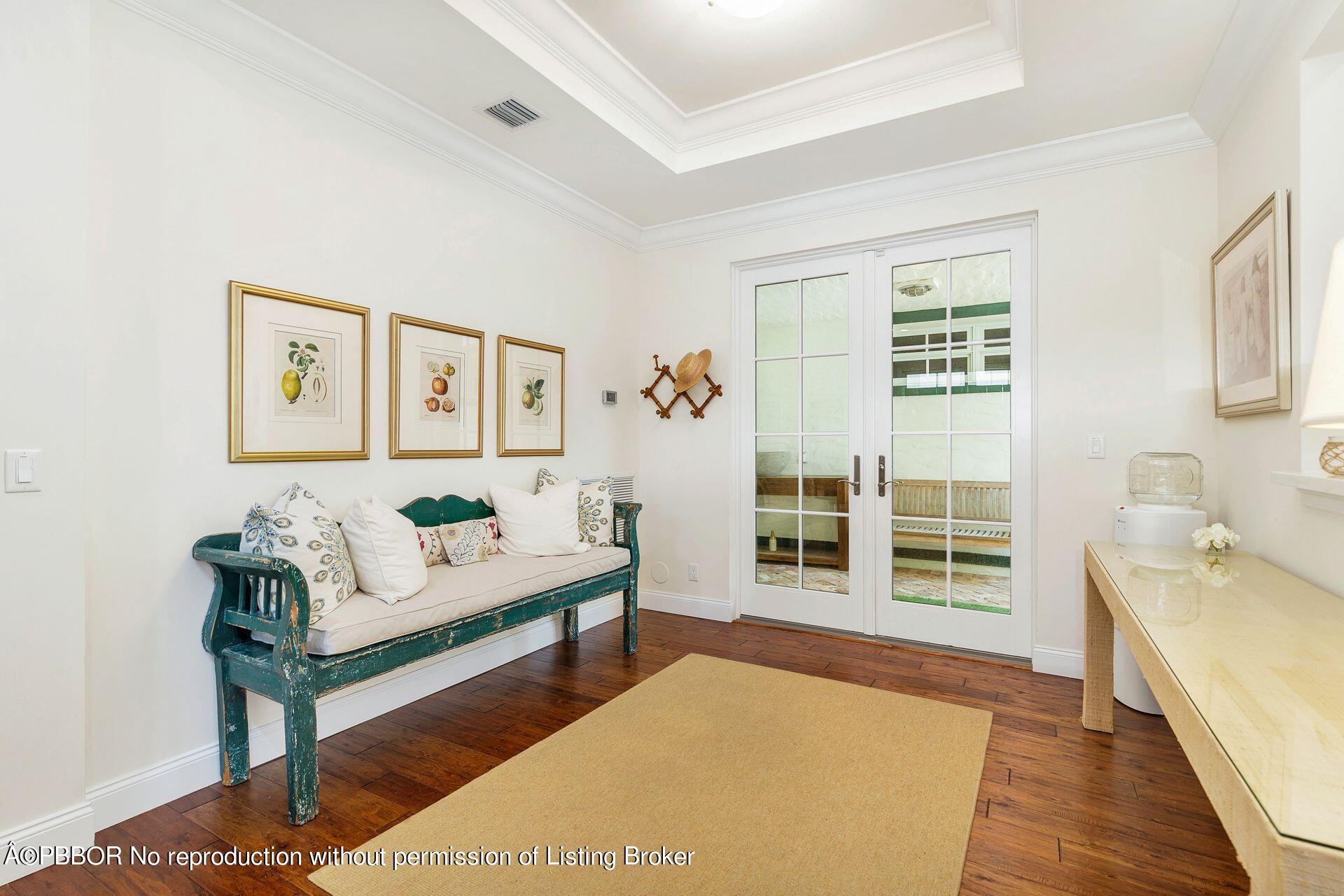 135 Root Trail, Unit A Palm Beach, FL 33480 - Photo 5 of 25 a spacious bedroom with a bed and a couch