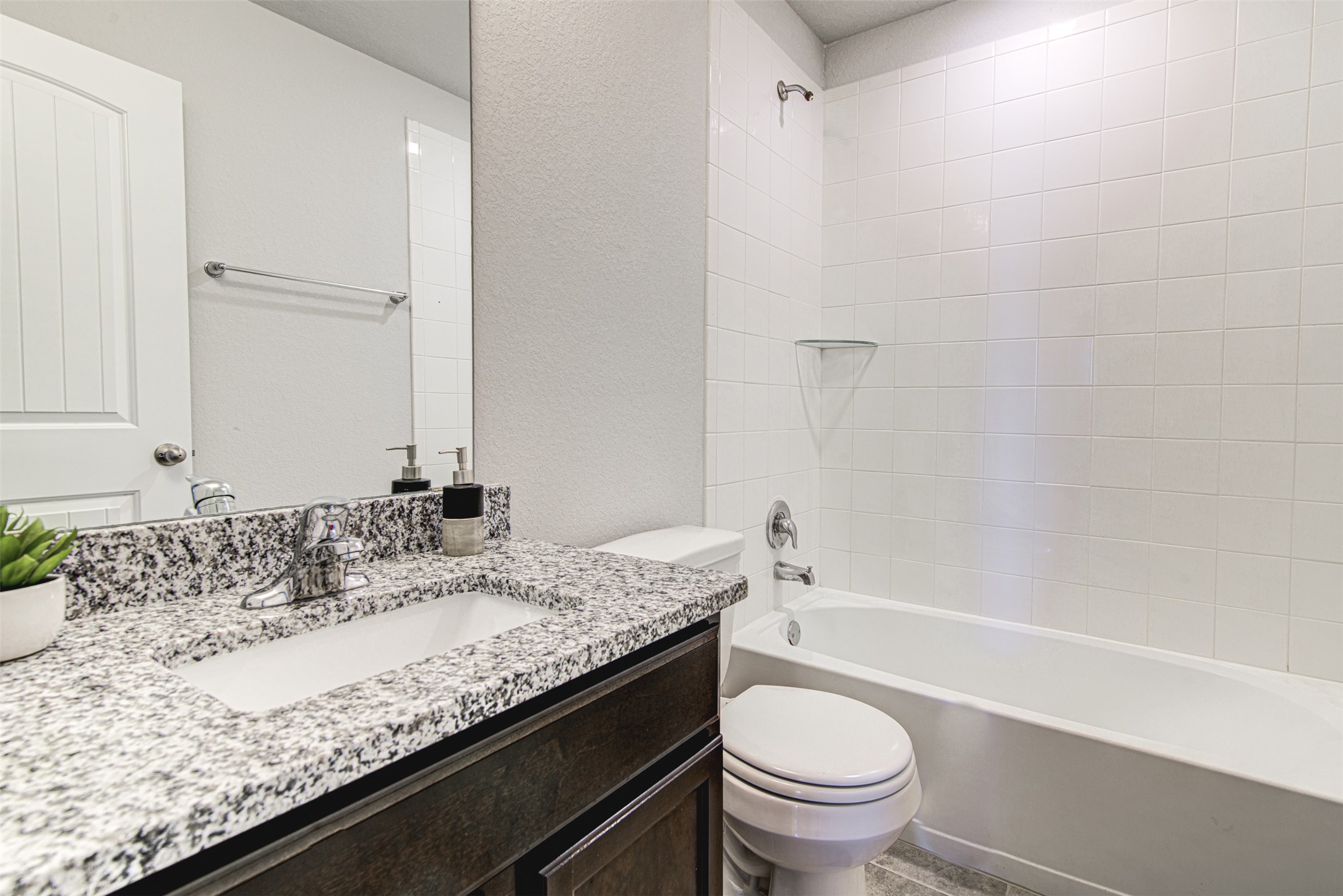 316 Pepper Mill Loop Burnet, TX 78611 - Photo 21 of 27 Granite counters and a tiled shower-tub combo create a clean and functional bathroom space.