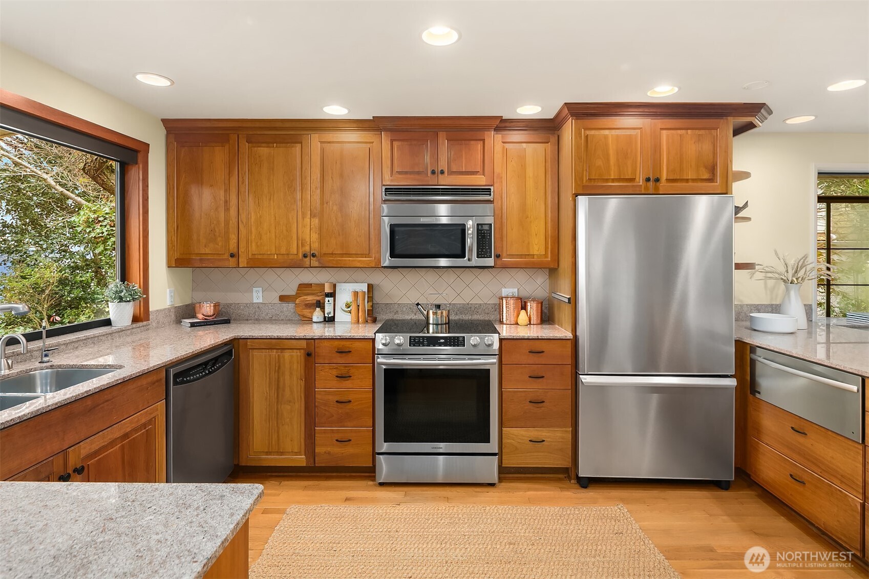 6555 Northeast Windermere Road Seattle, WA 98105 - Photo 14 of 38 a kitchen with stainless steel appliances granite countertop a refrigerator stove and sink