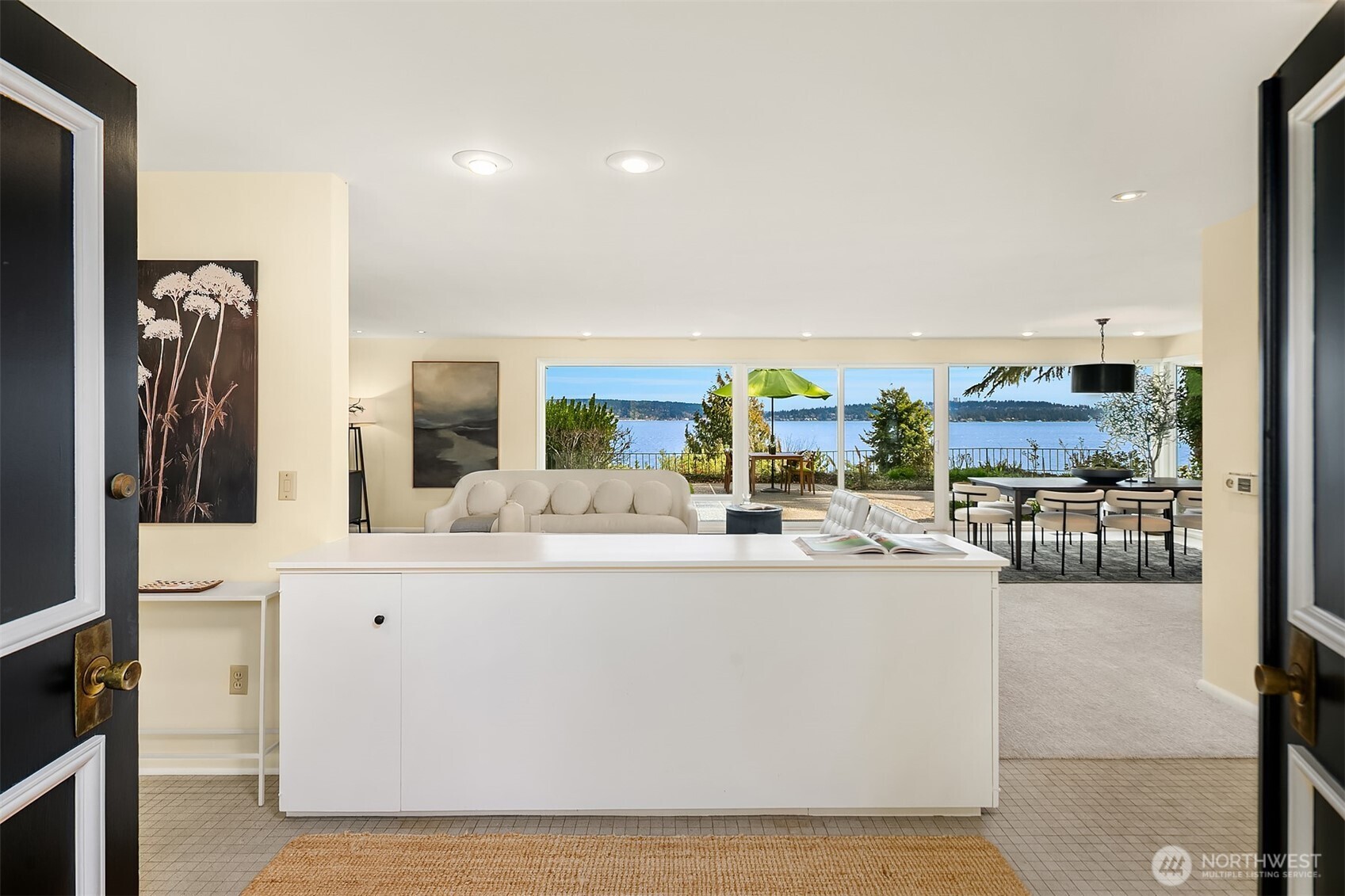 6555 Northeast Windermere Road Seattle, WA 98105 - Photo 4 of 38 a living room with stainless steel appliances kitchen island granite countertop furniture a rug and a view of kitchen