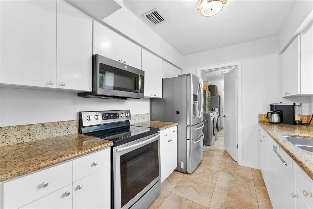 1257 Northwest 5th Street Boca Raton, FL 33486 - Photo 15 of 44 a kitchen with stainless steel appliances granite countertop a refrigerator stove and sink