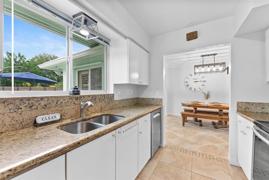 1257 Northwest 5th Street Boca Raton, FL 33486 - Photo 18 of 44 a kitchen with a sink and a stove top oven