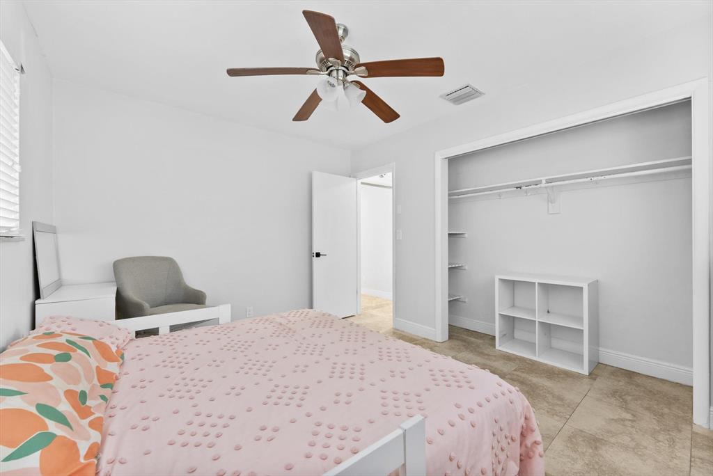 1257 Northwest 5th Street Boca Raton, FL 33486 - Photo 20 of 44 a bedroom with a bed and a ceiling fan