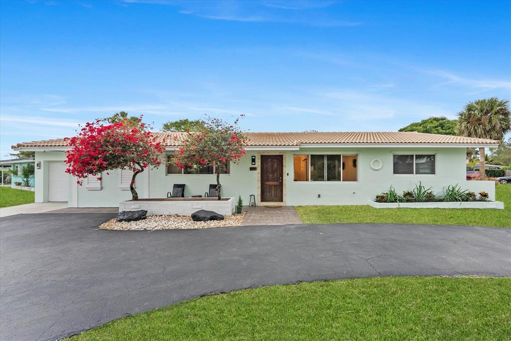 1257 Northwest 5th Street Boca Raton, FL 33486 - Photo 2 of 44 a front view of house with yard and green space