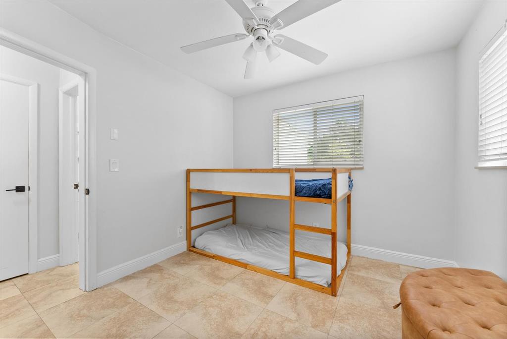 1257 Northwest 5th Street Boca Raton, FL 33486 - Photo 22 of 44 a room that has a bed and a table in it