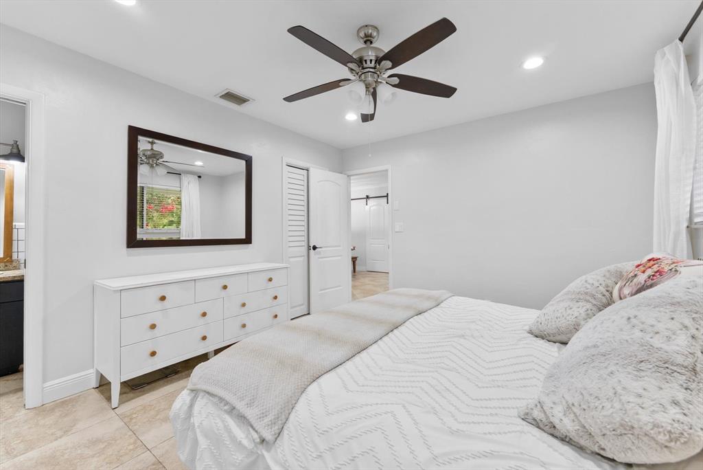 1257 Northwest 5th Street Boca Raton, FL 33486 - Photo 23 of 44 a bedroom with a bed and a lamp on dresser