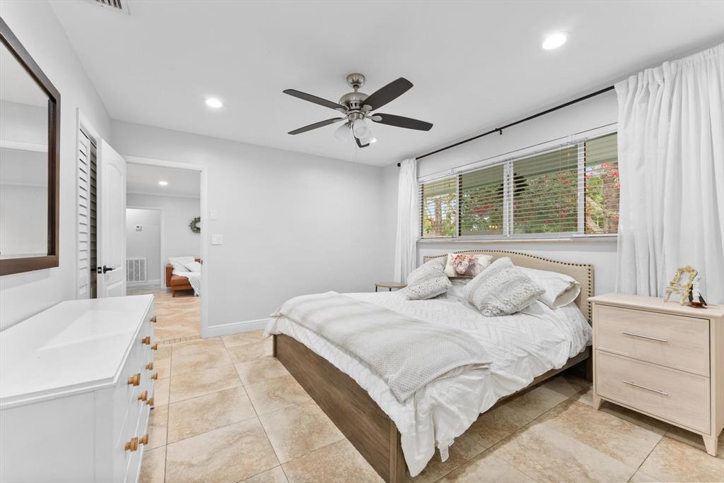 1257 Northwest 5th Street Boca Raton, FL 33486 - Photo 25 of 44 a bedroom with a large bed and a chandelier