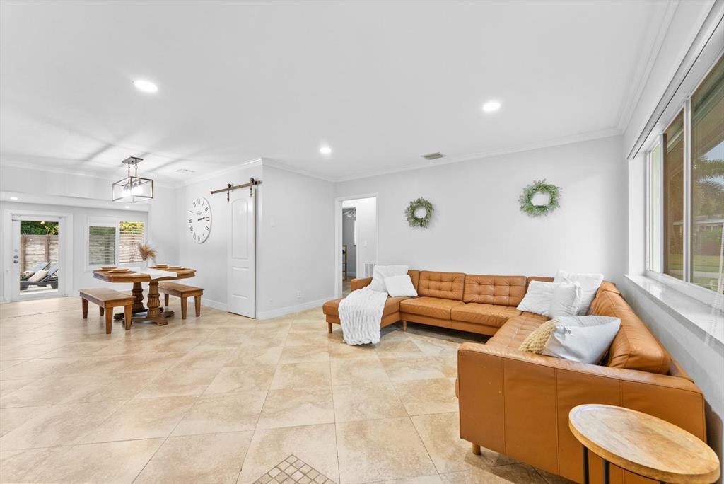 1257 Northwest 5th Street Boca Raton, FL 33486 - Photo 6 of 44 a living room with furniture and a dining table with kitchen view