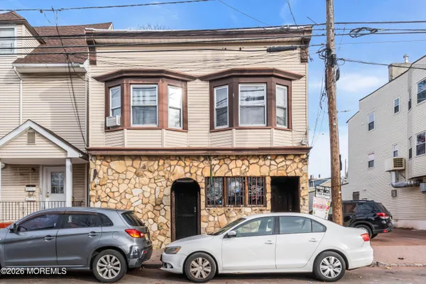 a front view of a house with parking space