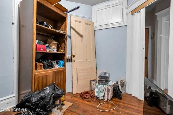 a bedroom with a bed and a mirror