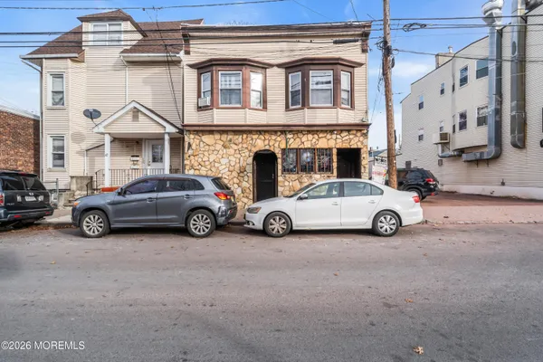 a view of a car parked in front of a house