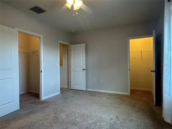 a view of an empty room with a closet
