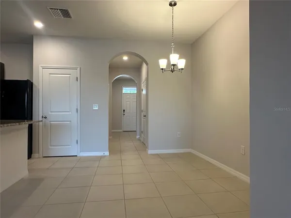 a view of a hallway with chandelier