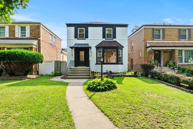 a front view of a house with garden
