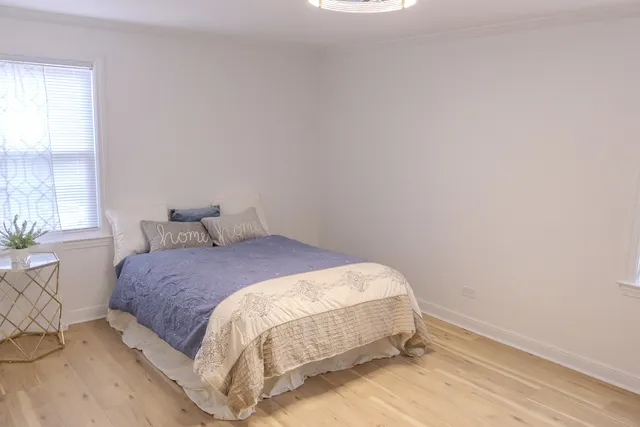 a bedroom with a bed and window