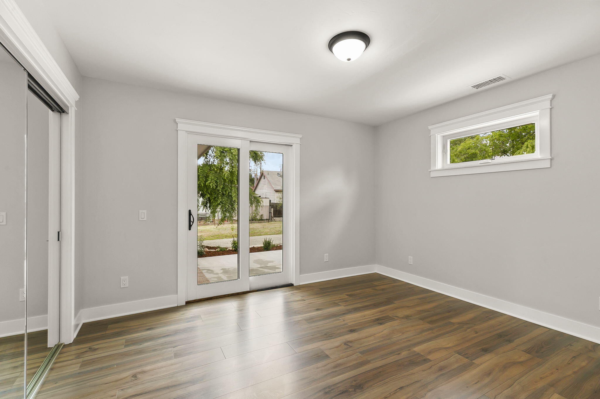 350 Old Grade Road Oak View, CA 93022 - Photo 41 of 59 an empty room with wooden floor and windows