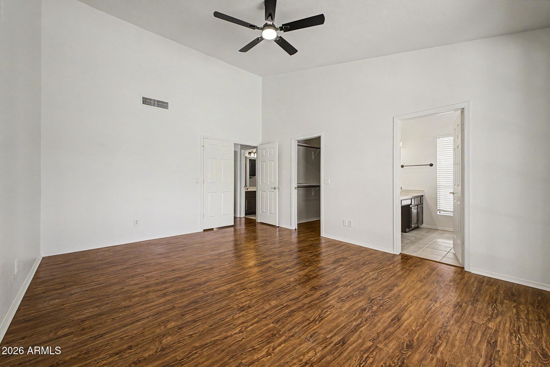 6725 West Utopia Road Glendale, AZ 85308 - Photo 14 of 27 a view of empty room with wooden floor and window