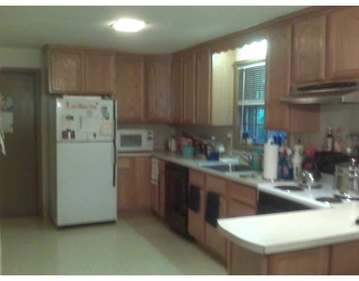 3 Santa Fe Road Chelmsford, MA 01824 - Photo 4 of 8 a kitchen with refrigerator and cabinets