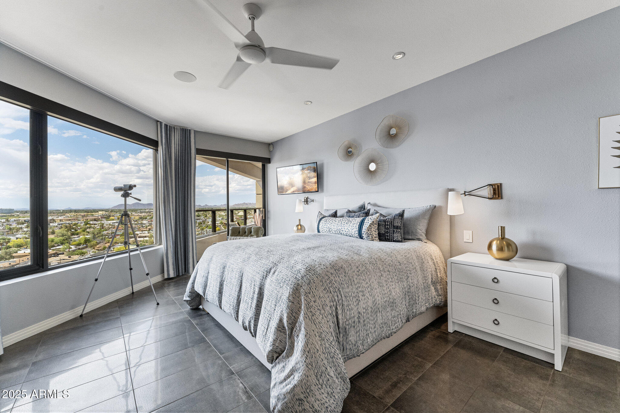 1040 East Osborn Road, Unit 1103 Phoenix, AZ 85014 - Photo 22 of 49 a spacious bedroom with a bed and large windows