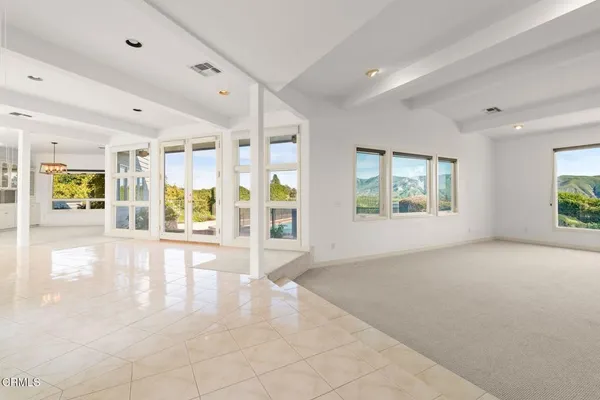 an empty room with windows and entrance