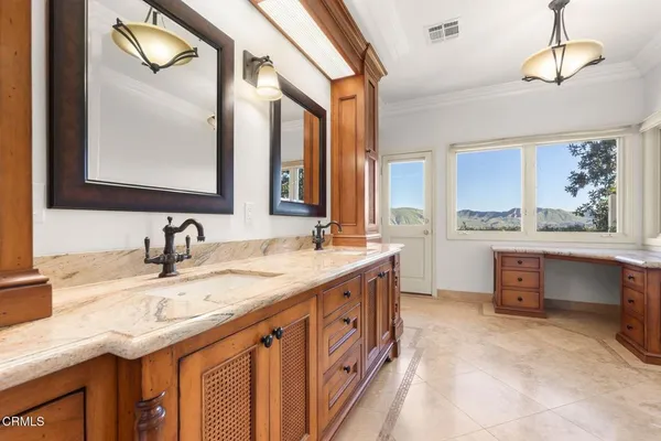 a view of walk in closet with wooden floor