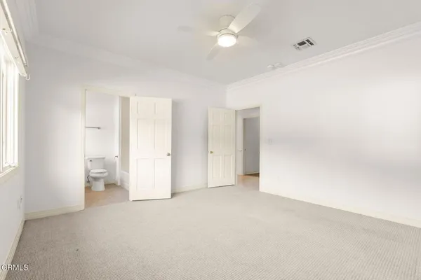 an empty room with windows and closet