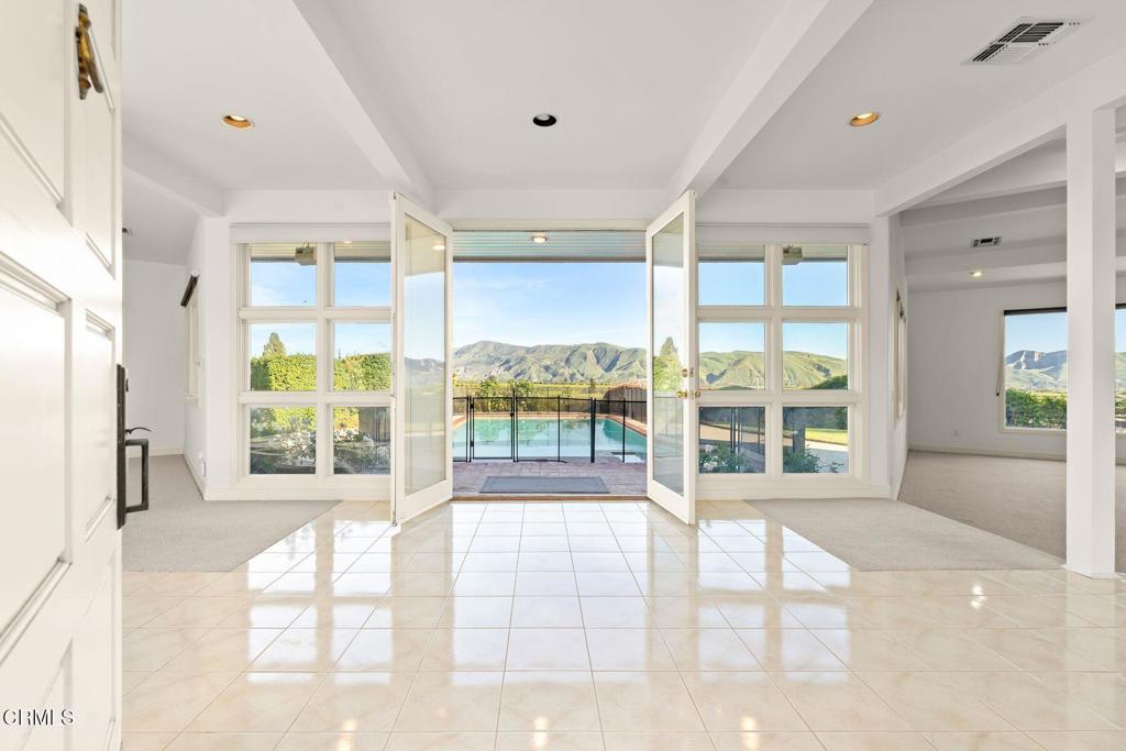 13922 Foothill Road Santa Paula, CA 93060 - Photo 4 of 36 a view of an empty room with wooden floor and a fireplace