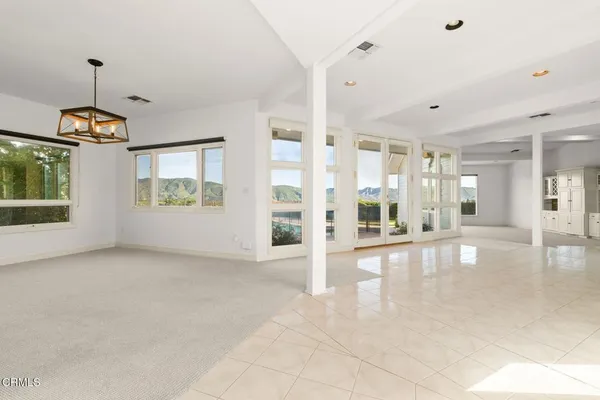 a kitchen with kitchen island granite countertop a stove and a wooden floors