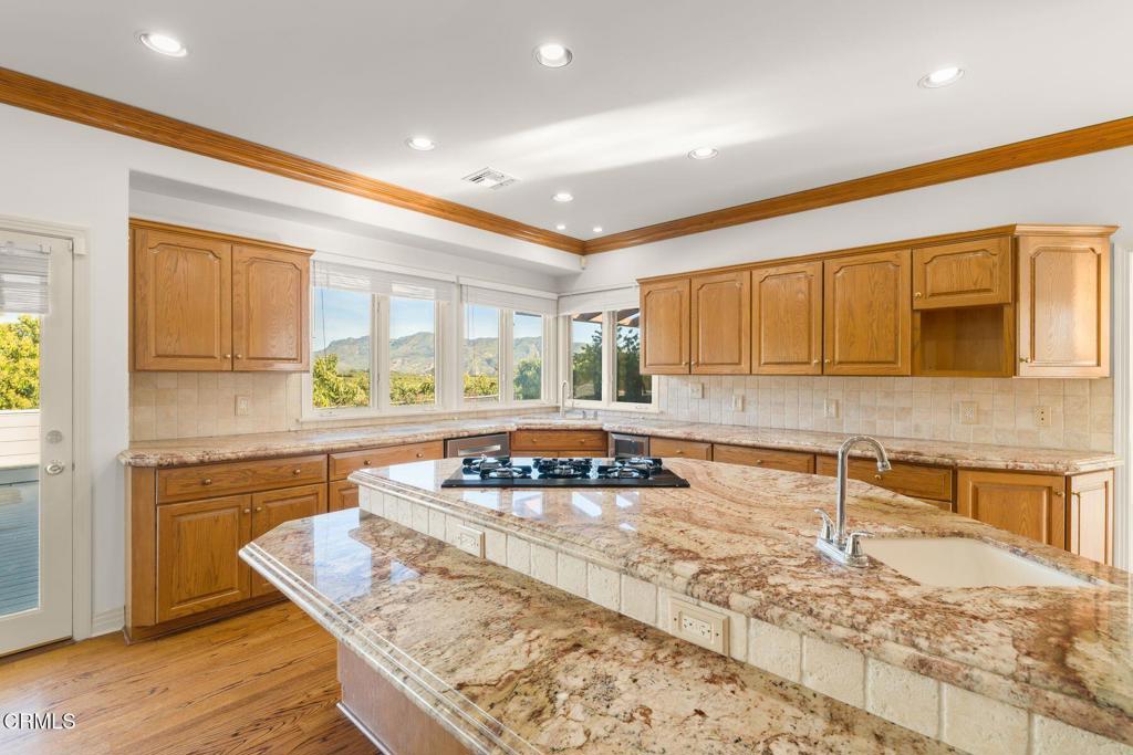 13922 Foothill Road Santa Paula, CA 93060 - Photo 7 of 36 a kitchen with a stove a sink and a refrigerator