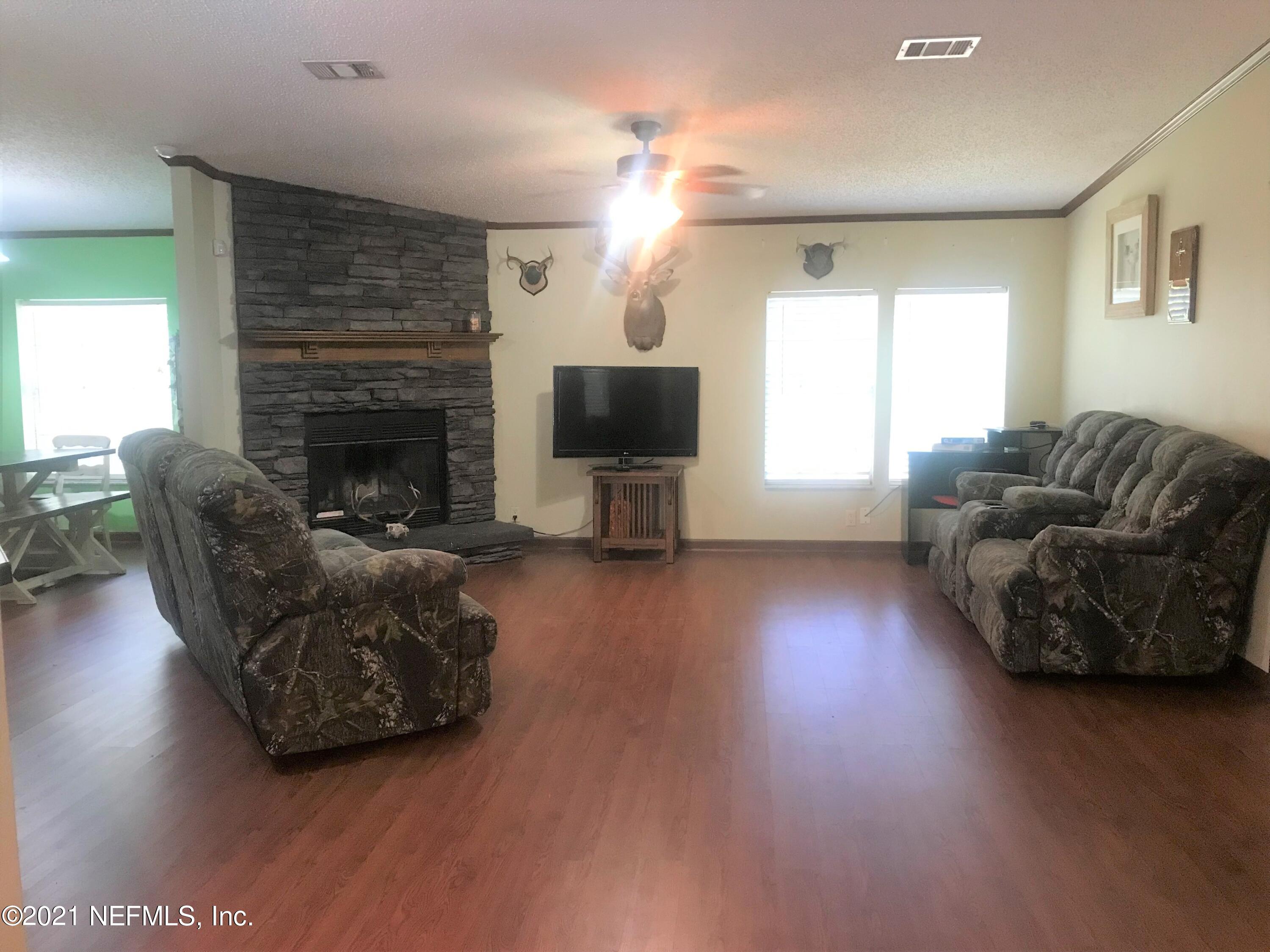 1860 Forbes Road St. Augustine, FL 32092 - Photo 4 of 24 a living room with furniture and a fireplace