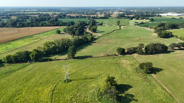 an aerial view of a houses with outdoor space and a lake view