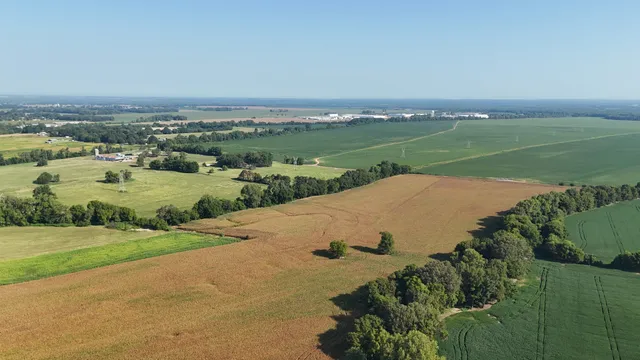 an aerial view of ocean with residential house and outdoor space