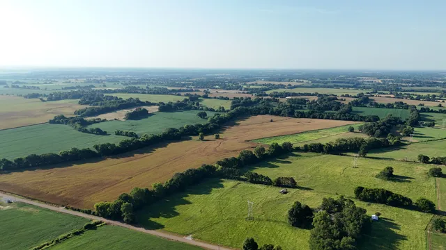 an aerial view of lake and residential houses with outdoor space