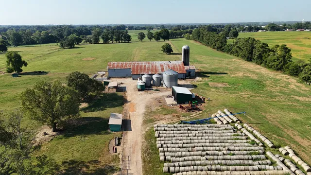 a view of a lake with a big yard and large trees
