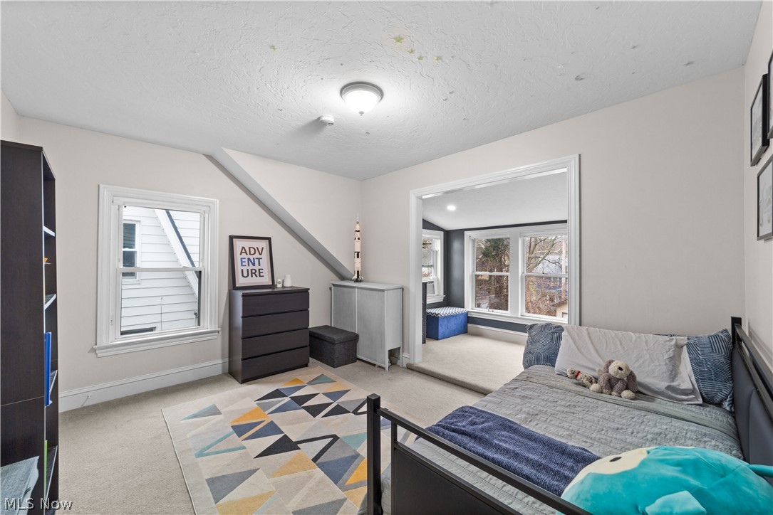 1680 Lee Road Cleveland, OH 44118 - Photo 20 of 45 Carpeted bedroom with a textured ceiling and vaulted ceiling
