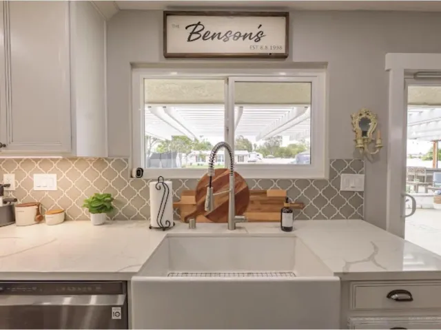 a large kitchen with stainless steel appliances granite countertop a stove oven and a refrigerator