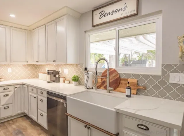 a kitchen with stainless steel appliances granite countertop a refrigerator stove and sink