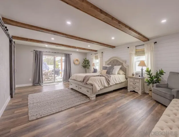 a bedroom with a bed and a potted plant