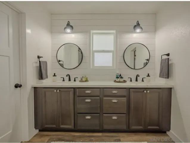 a view of a room with baby bed cabinet and front door
