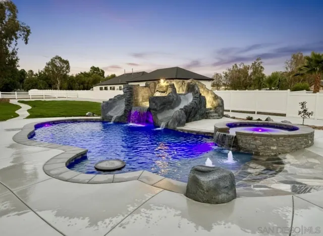 an aerial view of a house with yard swimming pool and mountain view