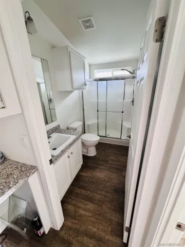 a view of a yard with wooden fence